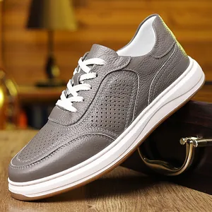 Close-up detail of grey pebble-grain leather men's sneakers with breathable holes