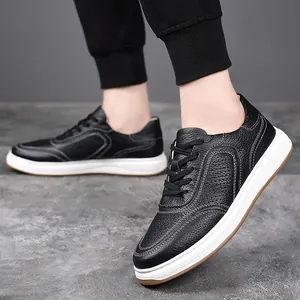 Close-up of black cowhide leather men's sneakers with white stitching and thick soles