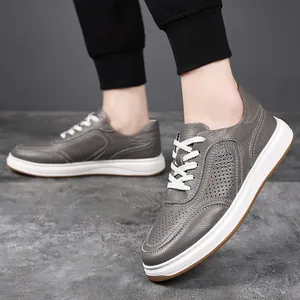 Detailed view of grey textured leather men's casual sneakers with perforated side panels