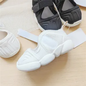 Detailed view of white breathable mesh children's sports sandals with a chunky rubber sole