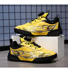 Vibrant yellow kids' turf soccer shoes featuring rotary dial laces and flame graphics