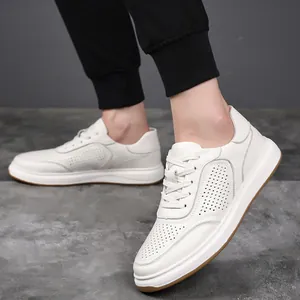 On-foot shot of white leather men's casual sneakers featuring breathable perforated details