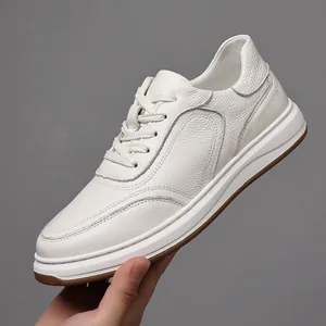 Close-up detail of white genuine leather sneaker for men showing premium pebble texture