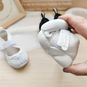 Detail shot of white toddler sneaker showing high flexibility and breathable mesh fabric