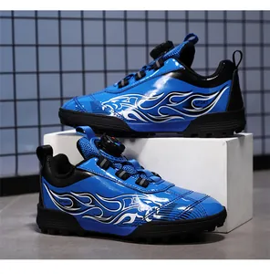 Side view of blue and black kids soccer turf shoes with flame pattern and rotary dial