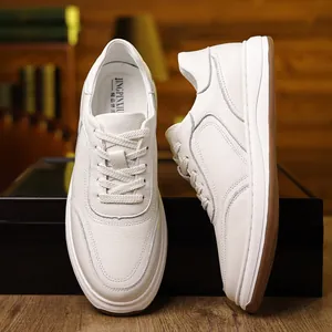 Close-up detail of white genuine leather men's sneakers showing premium grain texture