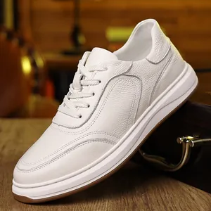 Close-up of premium white leather men's casual sneakers showing fine grain texture