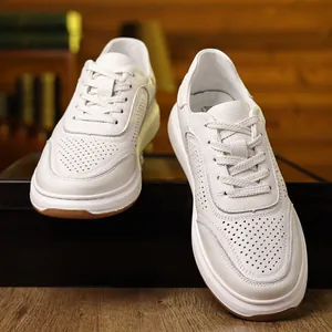 Close-up detail of premium white breathable leather men's sneakers on a wooden display stand