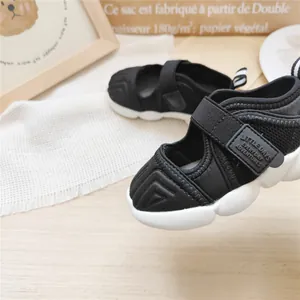 Detail view of breathable mesh and Velcro strap on black children's sport sandals