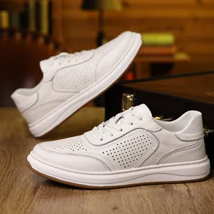 Detailed close-up view of white leather men's sneakers with breathable perforation detail
