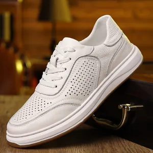 Close-up detail of white pebbled leather men's shoe featuring breathable perforated patterns