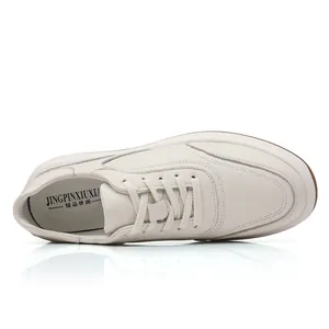 Macro view of minimalist cream leather shoe with lace-up detail and soft leather texture
