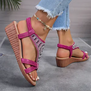 Detailed side view of fuchsia Bohemian rhinestone wedge sandals with elastic back strap