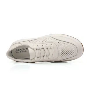 Top view of breathable off-white cowhide leather men's casual sneakers with perforated detail