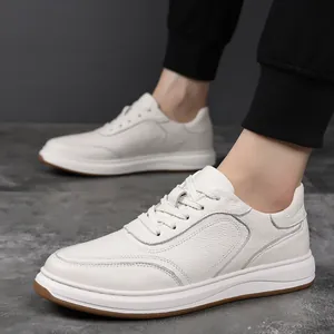 Detailed view of premium white leather men's sneakers with textured finish and soft sole.