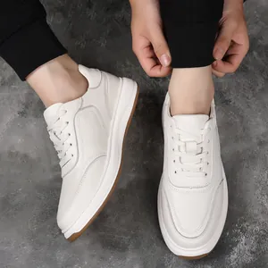 Detailed top view of white genuine leather men's sneakers with lace-up design