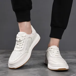 Close-up of breathable white cowhide leather sneakers for men featuring a gum rubber sole