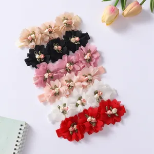 Detailed view of elastic baby headbands featuring multi-colored chiffon flower designs