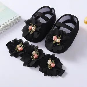 Detailed view of black soft-soled baby princess shoes and matching floral headband set
