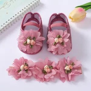 Detailed view of pink soft sole baby princess shoes and matching floral headband set