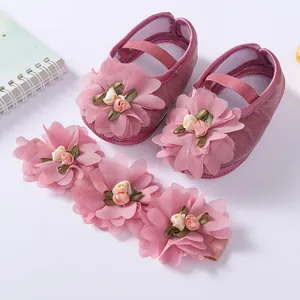 Detailed view of soft pink baby princess shoes with matching floral headband set