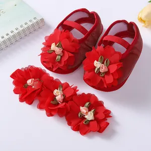 Detailed view of red baby princess shoes and matching three-flower headband set