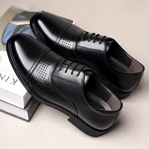 Detail shot of premium black leather business oxfords with perforated cap-toe design