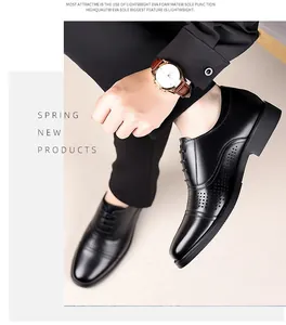Close-up of men's black genuine leather oxfords with decorative perforations