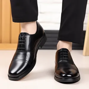 Close-up of black leather men's dress shoes with brogue details and lace-up design