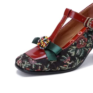 Close-up of vintage floral jacquard Mary Jane shoe with green bow and colorful beads