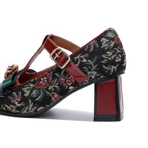 Close-up of vintage Mary Jane heel with floral tapestry and red patent leather