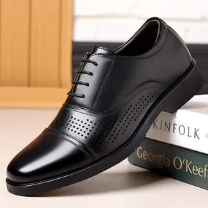 Detailed side view of high-quality black men's genuine leather dress shoes with brogue.