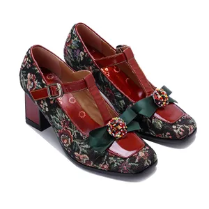 Close-up of vintage floral Mary Jane shoes with 3D green bow and bead detail