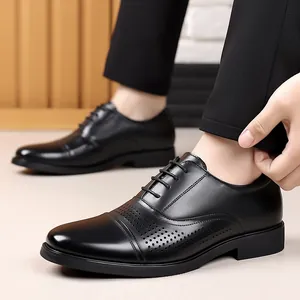 Close-up detail of premium black leather Oxford dress shoes featuring brogue perforations