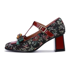 Side view of vintage Mary Jane pumps with floral tapestry and beaded bow detail.