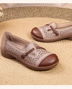 Detailed view of breathable hollowed-out leather loafers for elderly women in beige