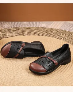 Detailed view of breathable hollow-out leather shoes with decorative knot for elderly women