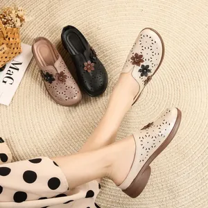 Comfortable hollow-out flat mules for women with floral design and non-slip soft sole.