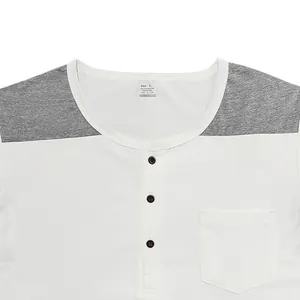 Close-up of men's Henley shirt with buttons, grey shoulder patches, and chest pocket detail
