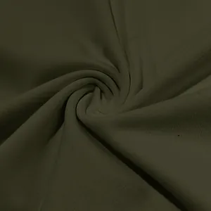 Macro close-up view showing the soft olive green fabric texture of a men's Henley shirt