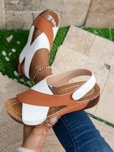Detailed macro view of stylish brown and white women's wedge platform sandals