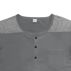 Close-up of grey color block Henley shirt with chest pocket and button neckline