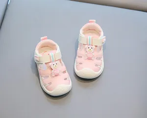 Adorable pink baby sandals with cartoon bear and soft anti-slip soles for toddlers.