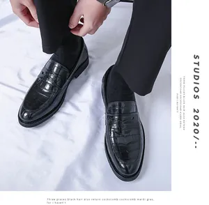 Detailed view of black crocodile pattern leather loafers for men in formal business style