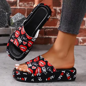 Detailed view of women's platform slides featuring red lip and white LOVE print pattern