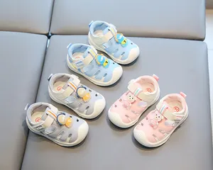 Detailed view of baby summer sandals in blue, grey, and pink with cute bear motifs