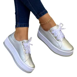 Women's metallic silver platform sneakers with thick white chunky sole and laces