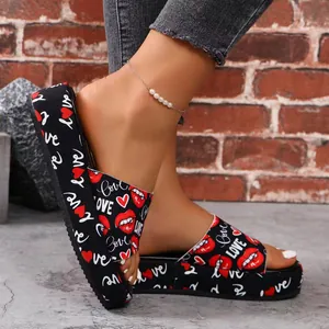Detailed view of women platform slides featuring vibrant red lip and heart prints.