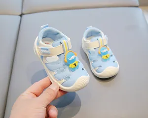 Close-up detail of blue toddler closed-toe beach sandals with cute astronaut character