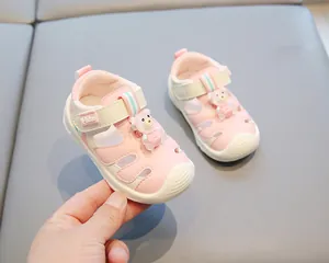 Close-up of pink toddler sandals featuring a cute 3D bear and secure Velcro strap.